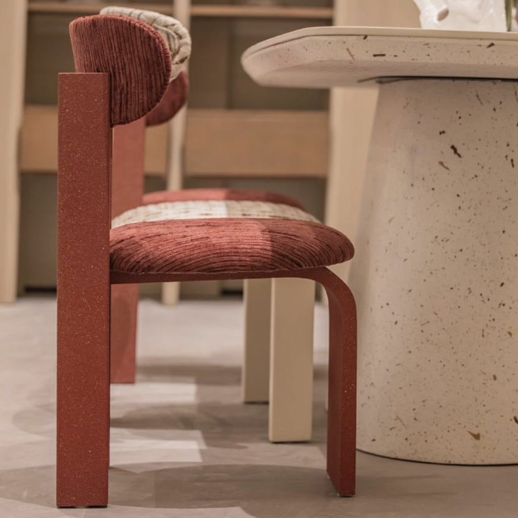 Side view of Arco chair showing arched back and textured wooden legs