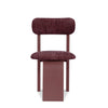 Arco dining chair in deep red velvet with sculptural curved back