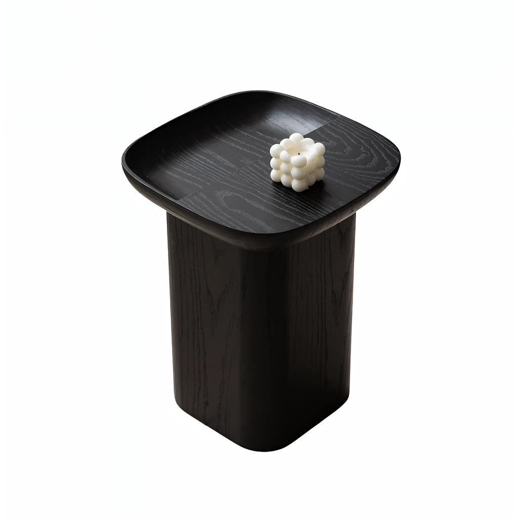Black ashwood accent table featuring a soft square top and rounded pedestal body