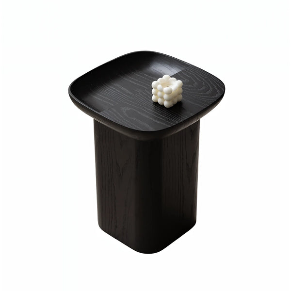 Black ashwood accent table featuring a soft square top and rounded pedestal body