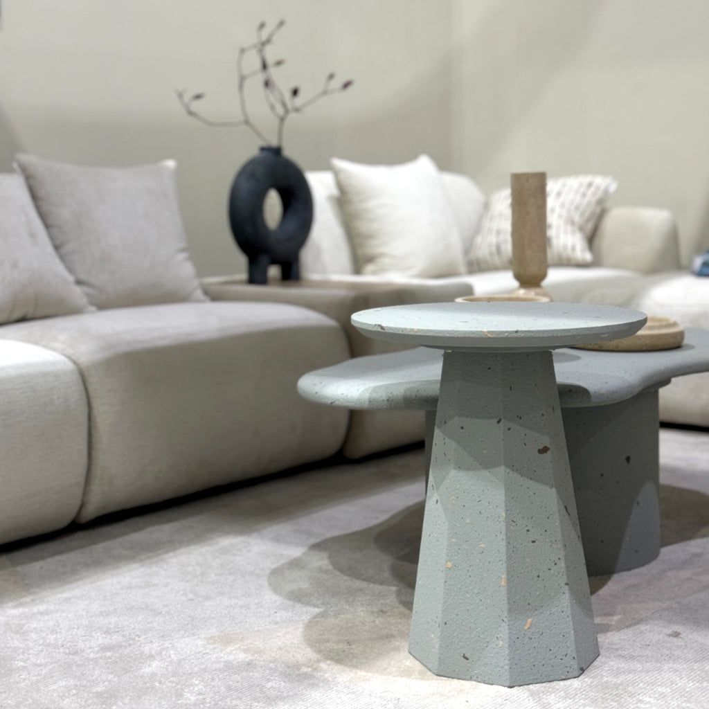 Contemporary speckled coffee tables styled together for layered look