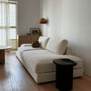 Compact ashwood side table with a sculptural silhouette and smooth curved edges