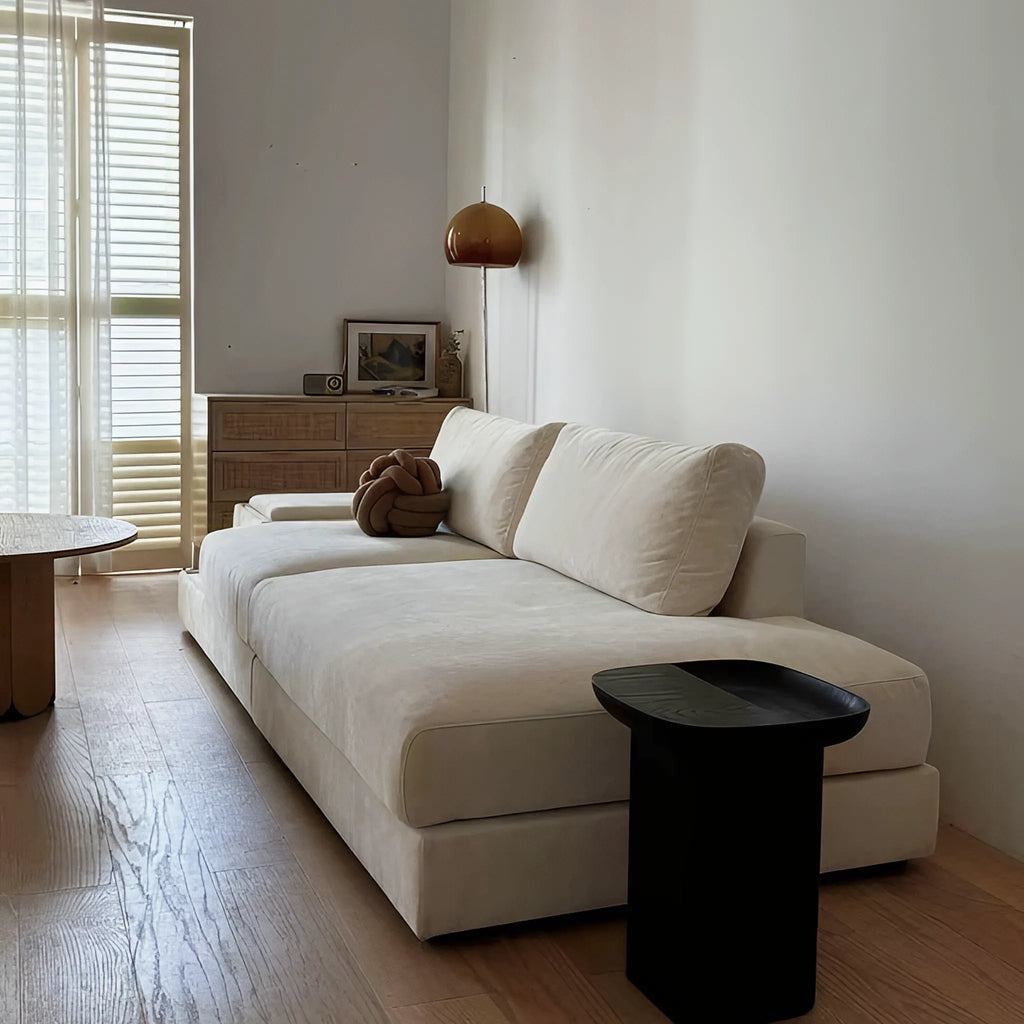 Compact ashwood side table with a sculptural silhouette and smooth curved edges