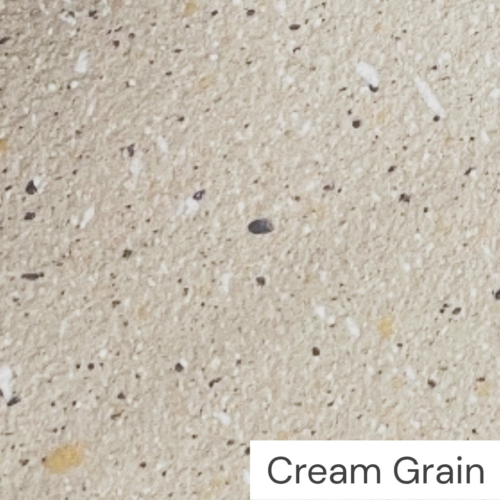 Modern organic design coffee table featuring cement-like textured in cream grains