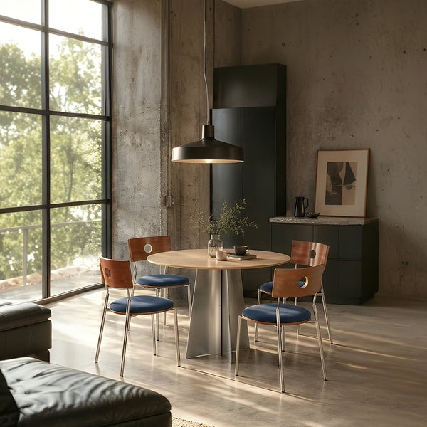 CRUX and PORTO 4-seater round dining set with blue cushioned chairs in a modern industrial-style dining room