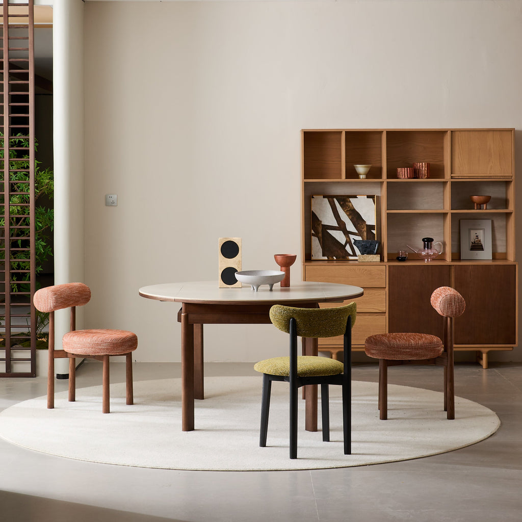 PILLO Dining Chair paired with round wooden dining table set in mid-century modern design.