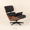 Eames Lounge Chair And Ottoman crafted in beech wood and genuine leather. Walnut and black.
