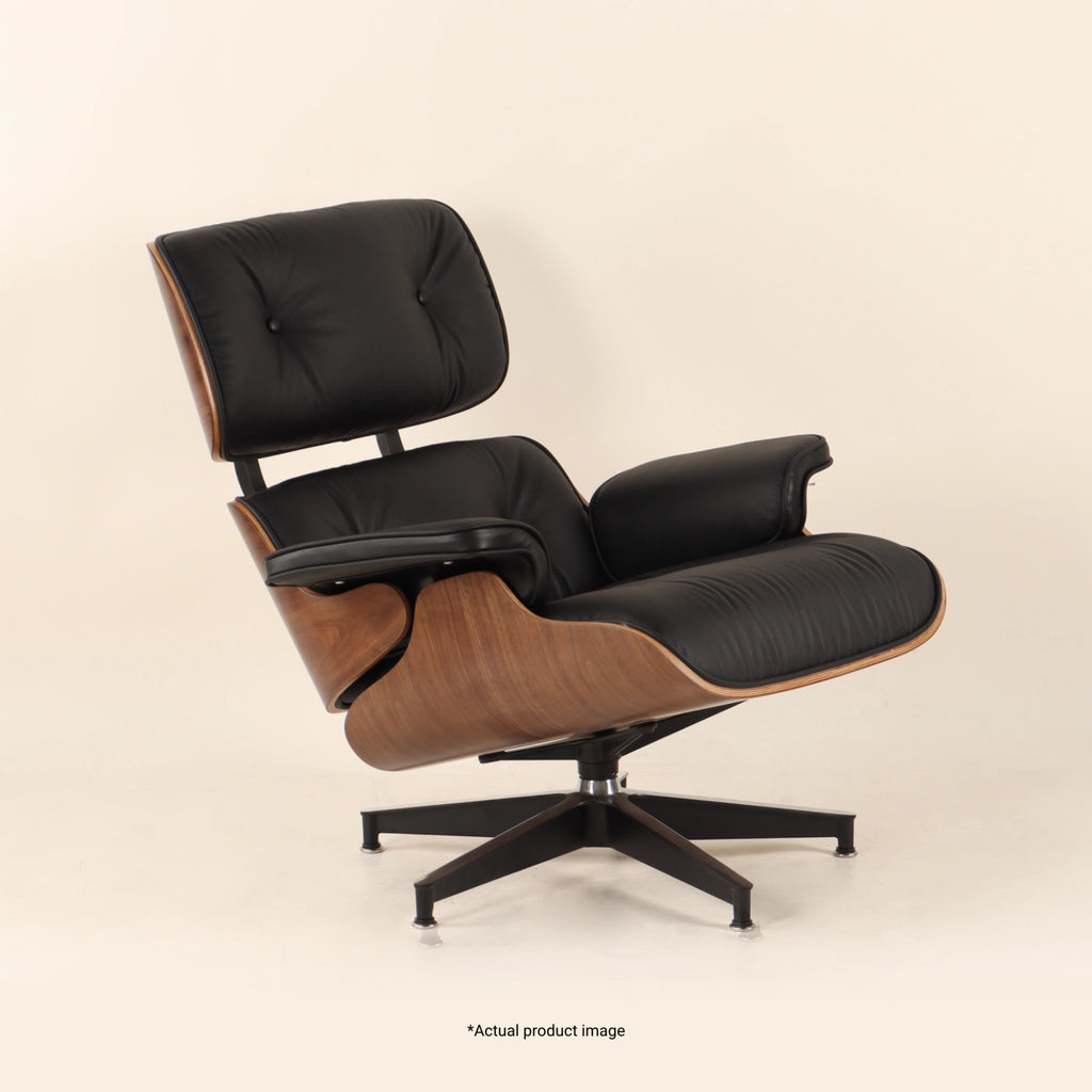 Eames Lounge Chair And Ottoman crafted in beech wood and genuine leather. Walnut and black.