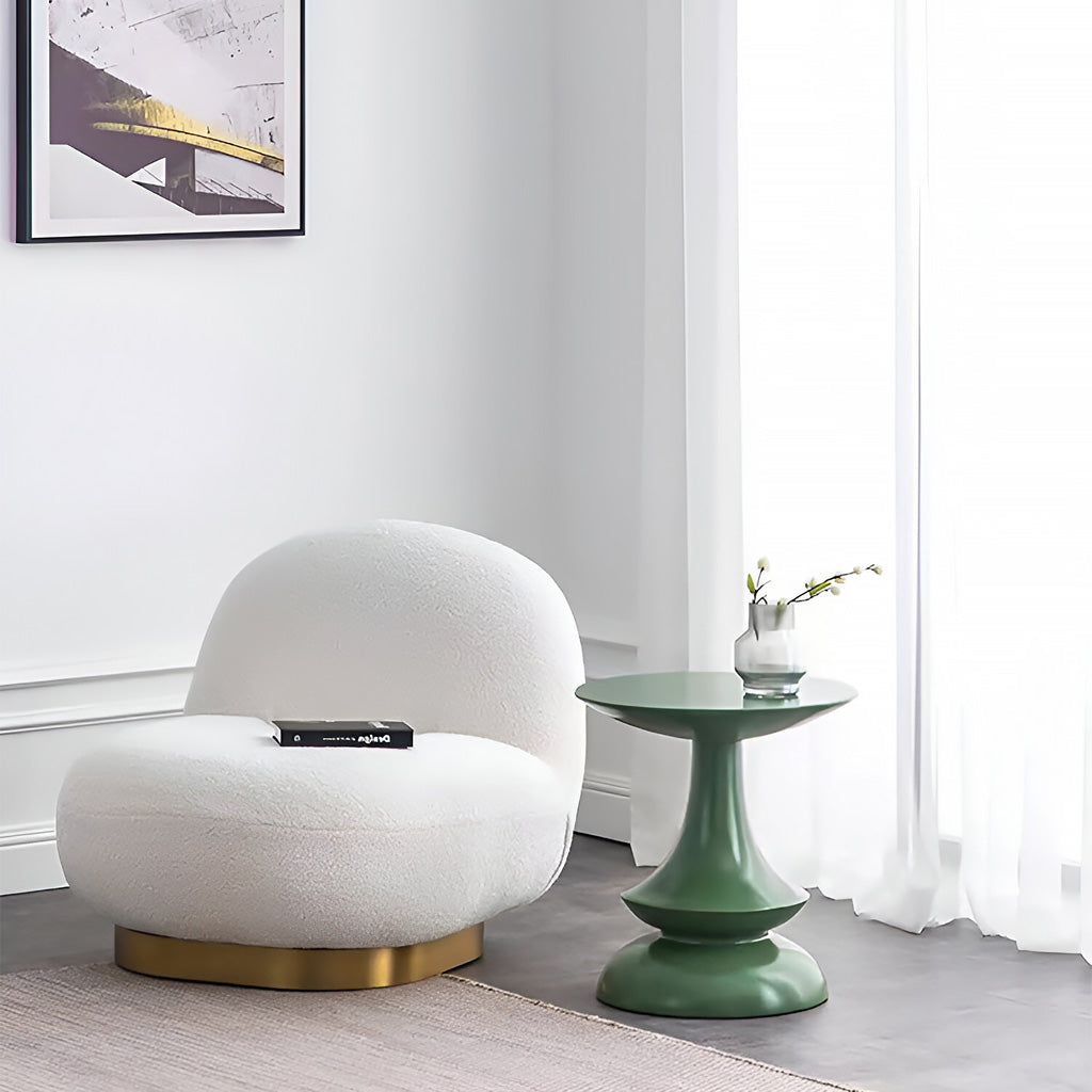 Lounge area decorated with elegant round side table with unique geometrical shape