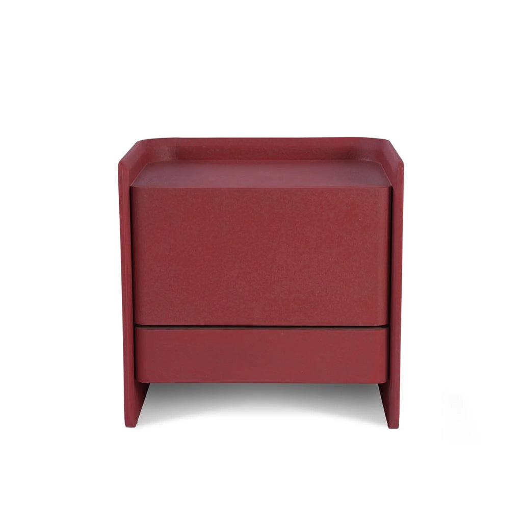 Modern bedside table with clean lines rounded edges and a cement texture paint finish for a bold industrial chic bedroom look