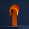 Side view of designer lamp, unique curved structure, warm ambient lighting, steel matte in vibrant orange.