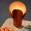Warm table lamp featuring unique design.