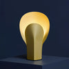 Yellow Gold table lamp featuring a unique design and structure. Bold interior design decor.
