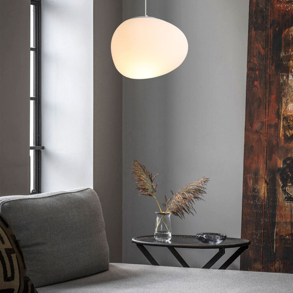 Minimalist, modern and elegant pendant light in white organic pebble shape lounge area