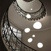 Minimalist, modern and elegant pendant light in white organic pebble shapes stairway design