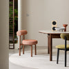 PILLO Dining Chair styled beside a modern dining table in a contemporary resort-style dining room.