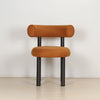 ROLO dining chair in caramel linen, front view showing the rounded seat and rolled backrest.
