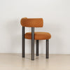 Side profile of the ROLO dining chair showing the backrest curve and tubular steel legs.