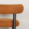 Close-up of ROLO dining chair's linen fabric in warm Caramel color
