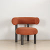 ROLO lounge chair in caramel photographed in a room, on slim tubular steel legs.