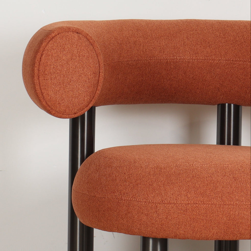 Close view of the ROLO lounge chair's softly rounded, linen texture, and stitching detail.