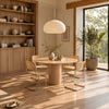Four-seater RONAN round wood dining table with ONTTO cane chairs in a warm Japandi-style dining room.