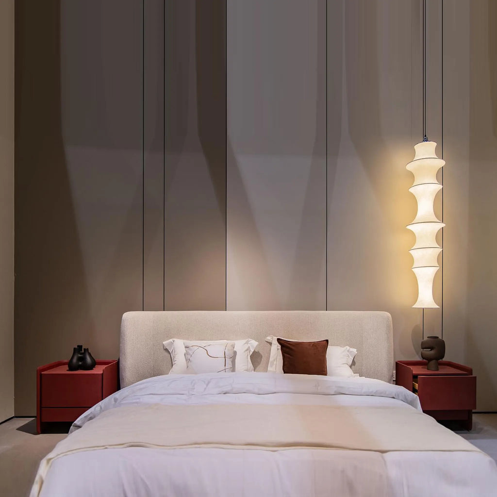 Sleek bedside table featuring smooth curves practical storage and a cement textured paint effect for a stylish modern touch