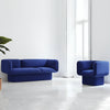 Sleek blue velvet Todd sofa featuring soft curves and a sculptural pedestal base