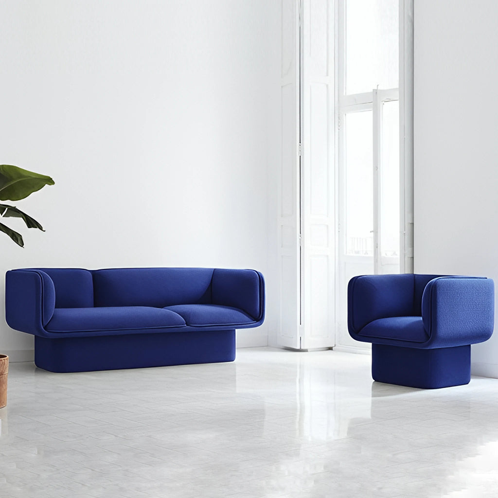 Sleek blue velvet Todd sofa featuring soft curves and a sculptural pedestal base