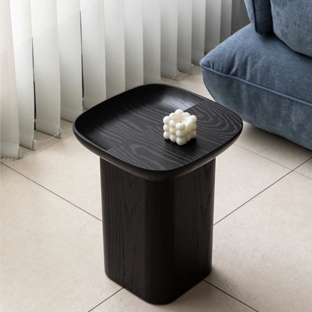 Sophisticated black ashwood end table with a clean geometric shape and natural wood grain