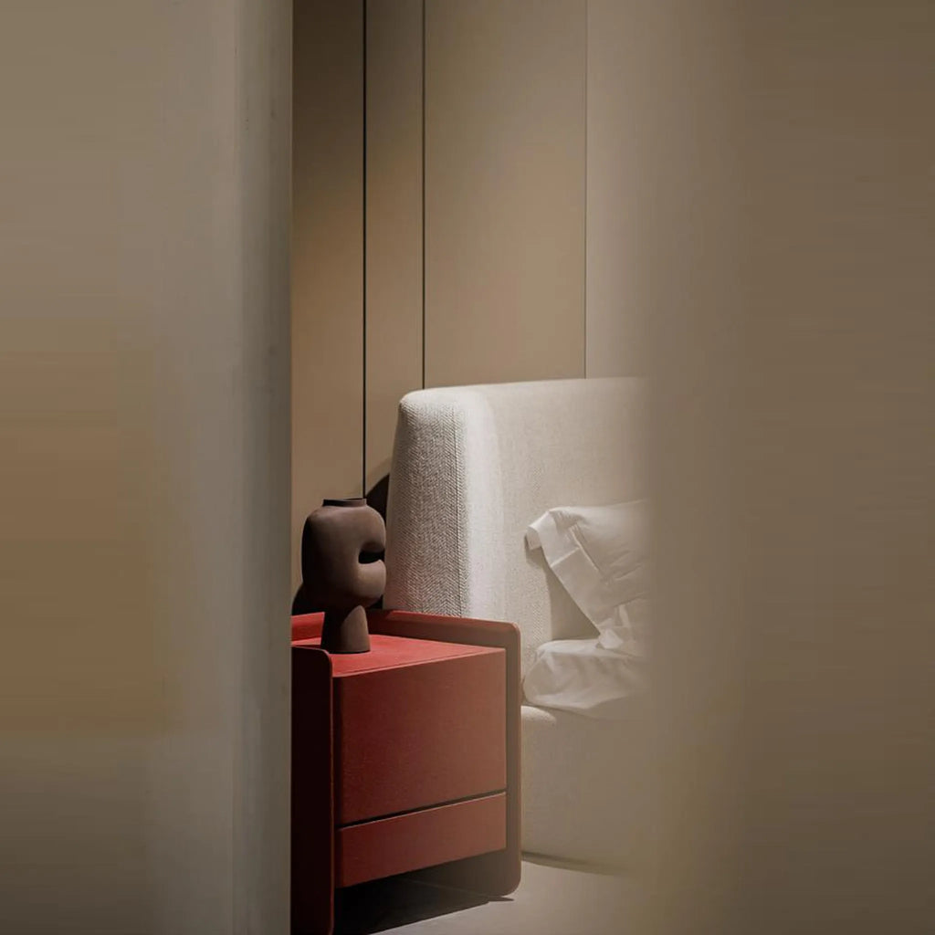 Stylish nightstand with cement textured paint surface clean boxy design and storage drawers for a sleek modern bedroom