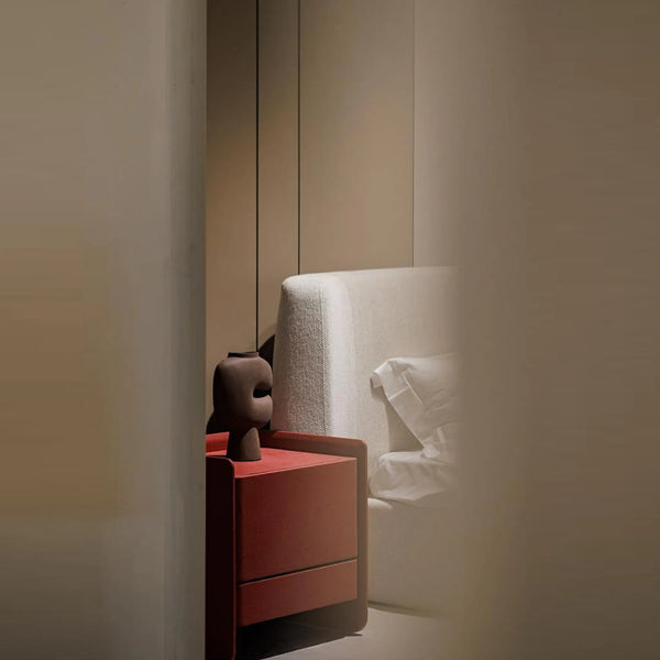 Stylish nightstand with cement textured paint surface clean boxy design and storage drawers for a sleek modern bedroom
