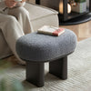 Stylish bouclé stool with oval seating and sturdy metal legs. Contemporary furniture for living room.