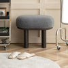 Stylish bouclé stool with oval seating and sturdy metal legs. Contemporary furniture. Seating Stool.