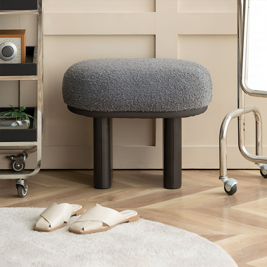 Stylish bouclé stool with oval seating and sturdy metal legs. Contemporary furniture. Seating Stool.