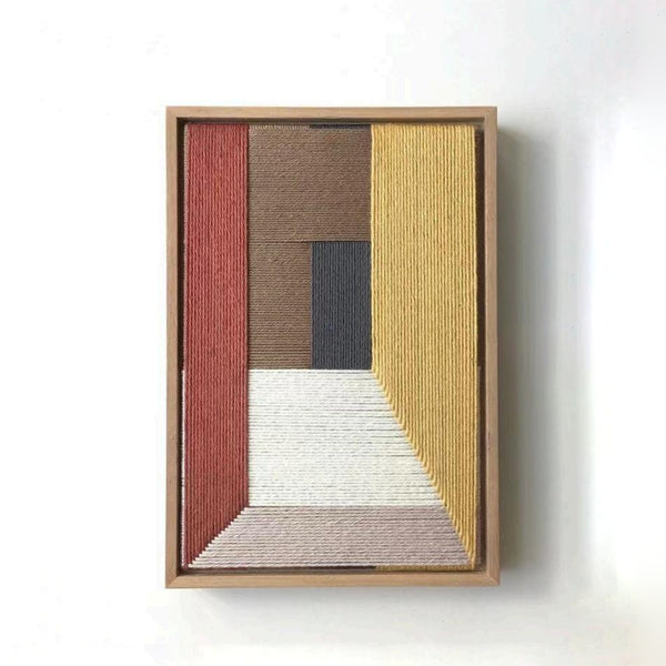 Modern textile art with geometric pattern framed in wood