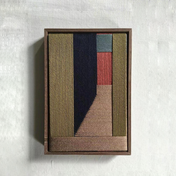 Geometric hand-woven wall art in warm and earthy tones