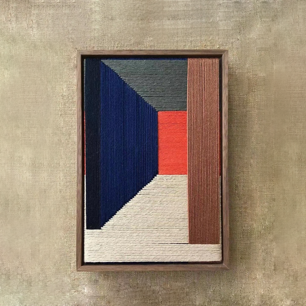 Modern fibre artwork framed in wood with colour-block design