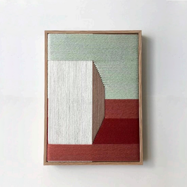 Hand-woven fibre wall sculpture with architectural linear pattern