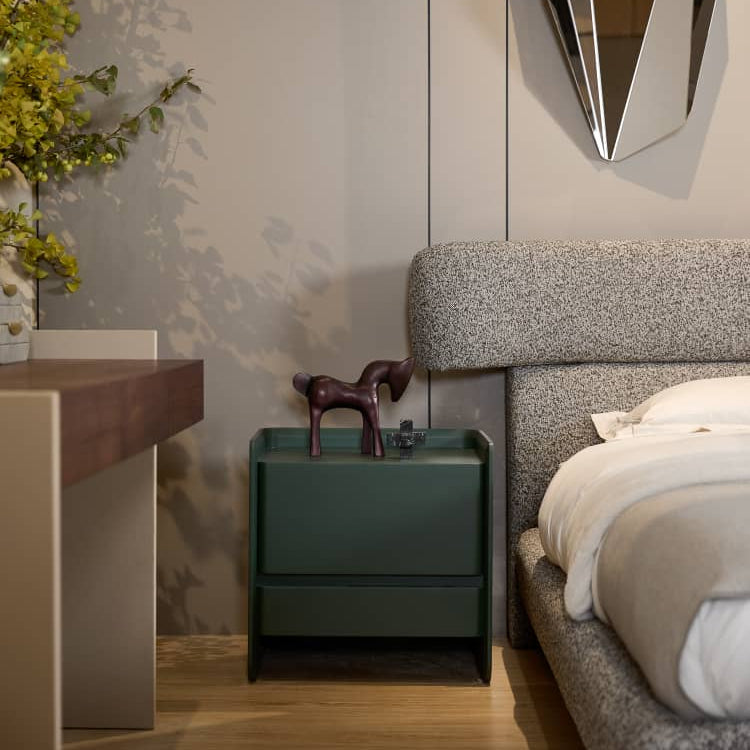 Modern bedroom with a green nightstand, gray bed, and decorative mirror.