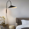 Modern and minimalist Willow Wall Lamp for living room - Steel surface in matte black finish.